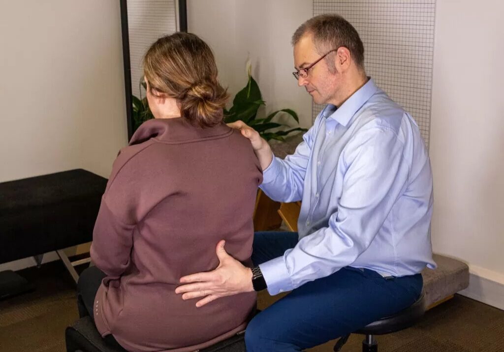 Milton Keynes chiropractor helping a patient with back pain